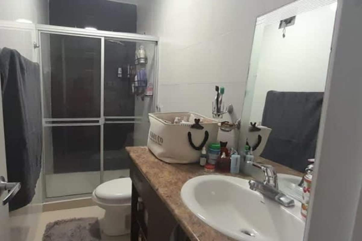 Contemporary bathroom with glass enclosed shower and granite sink PH Dos Mares Panama
