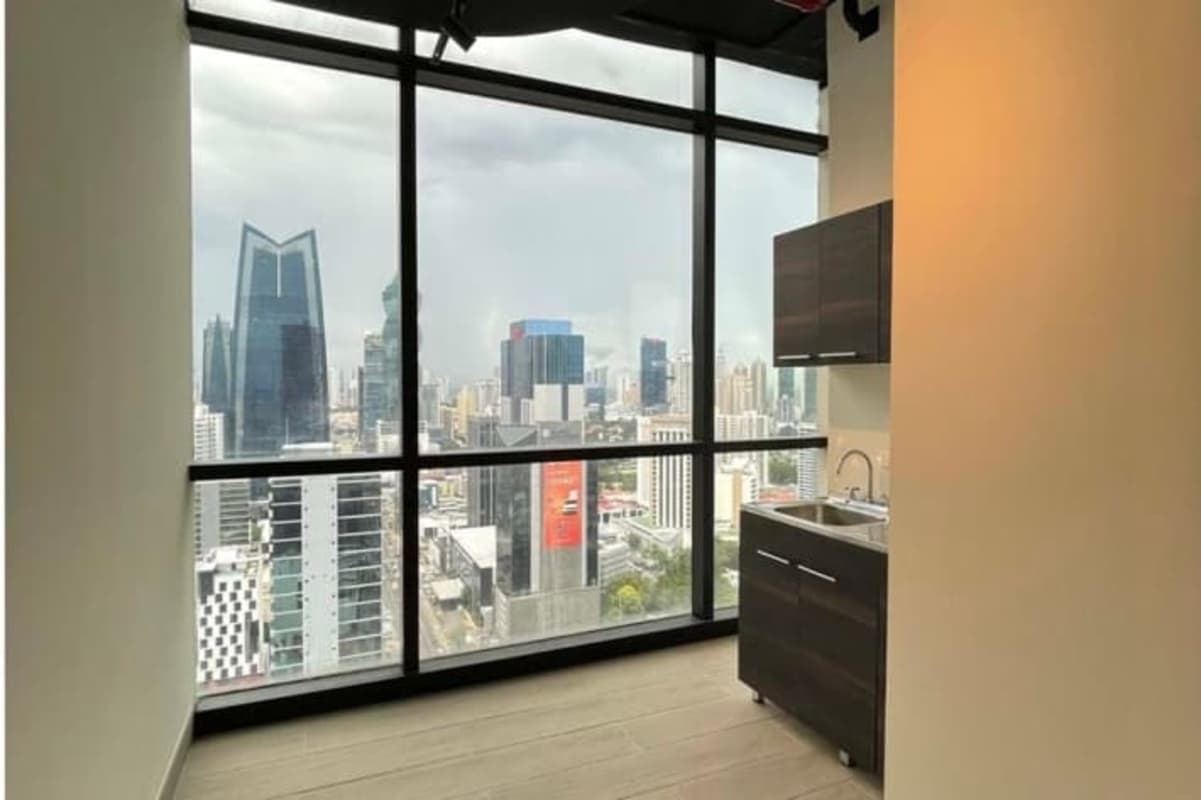 Tall glass windows with Panama City skyline view in modern office Tower Financial Center Obarrio