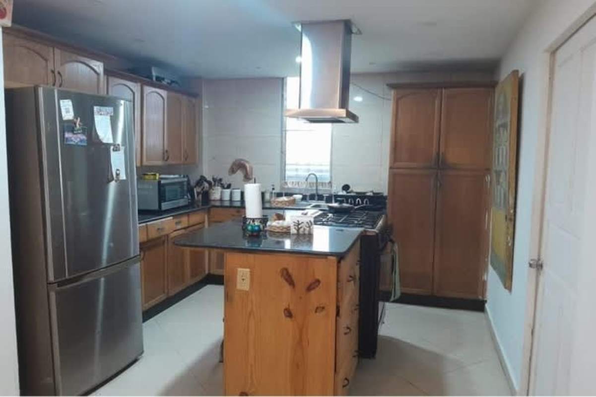 Traditional kitchen with center island and cabinetry commercial house Panama City