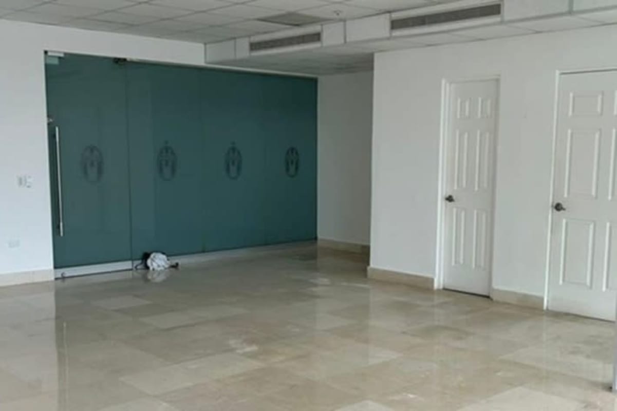 Private glass-partitioned office rooms and open workspace in PH BICSA Panama City