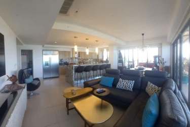 Modern open living area with floor-to-ceiling windows and Pacific view PH Punta Caelo