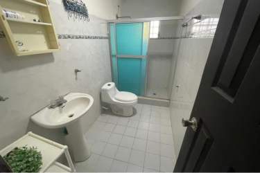 Modern bathroom pedestal sink glass shower tile floor residential house Gorgona Panama