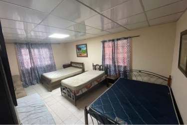 Rustic stone barbecue grill outdoor kitchen covered patio residential house Gorgona Panama