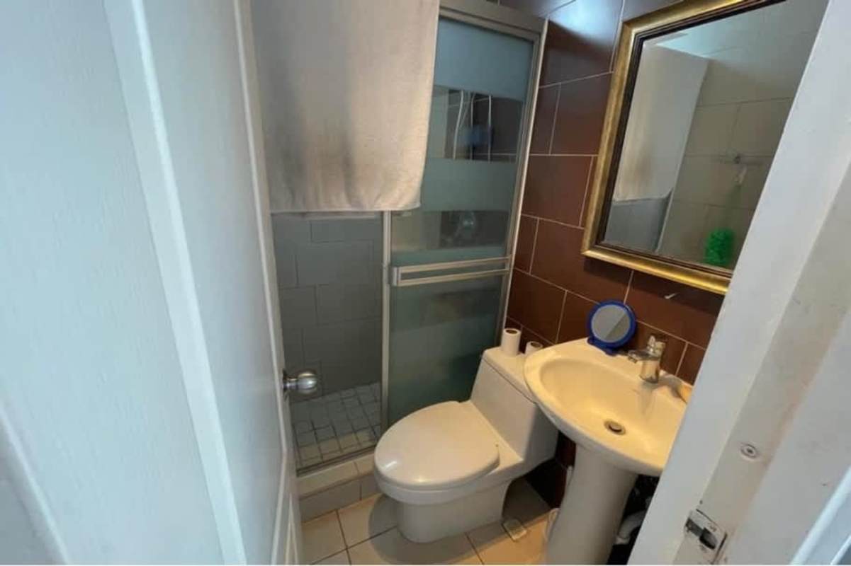 Second bedroom with window, ceiling fan at PH Albrook Point apartment Panama