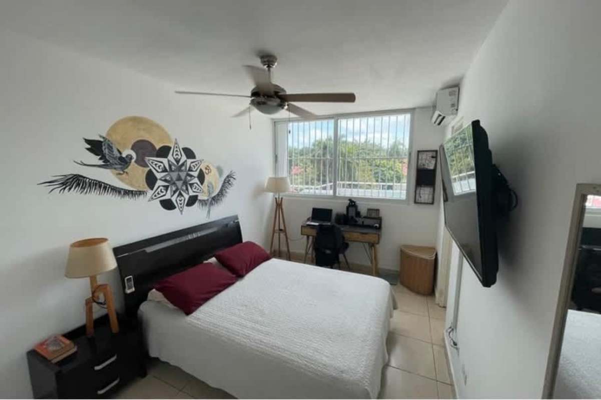 Bedroom with workspace, window security bars, AC unit in PH Albrook Point