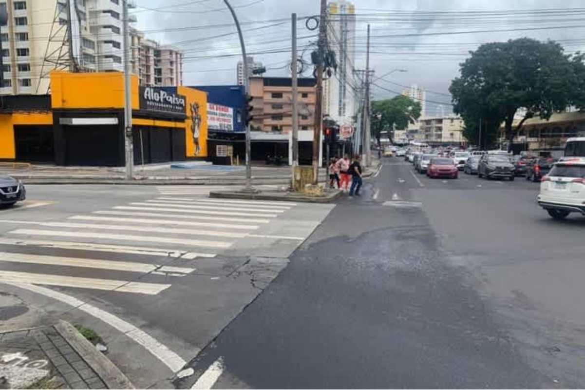 Busy urban street corner with commercial buildings and traffic Panama City