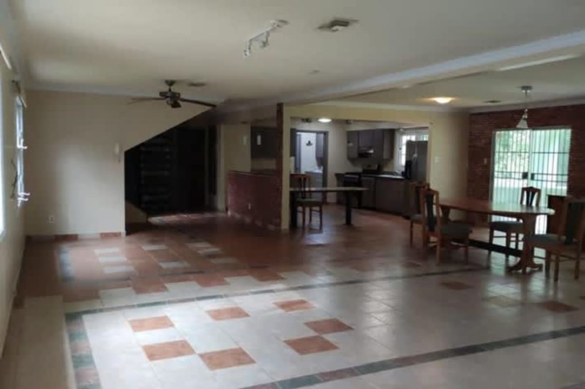 Spacious dining and kitchen area with breakfast bar and tiled floors in Clayton rental house