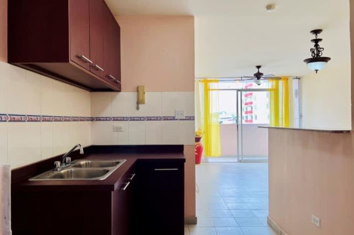 Apartment kitchen with wood cabinets, double sink, decorative tile in Panama for rent