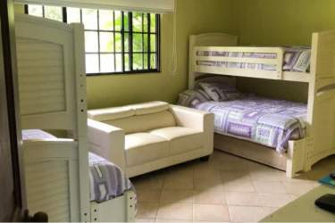 Luxurious bathroom with blue mosaic tiles, modern vanity, glass shower door in beachfront villa Costa Esmeralda Panama