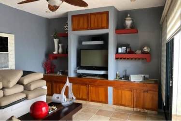 Contemporary living room with built-in entertainment center in Costa Esmeralda beachfront villa Panama