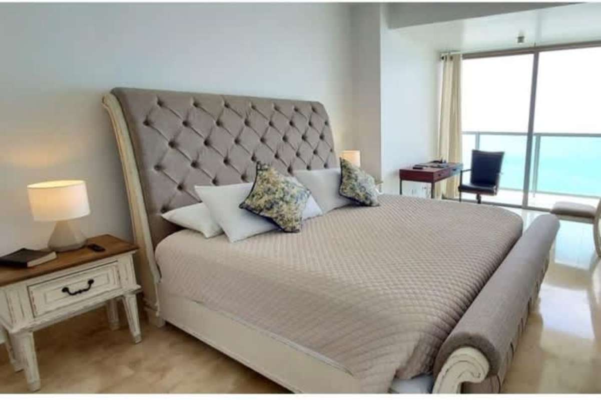Bright master bedroom with panoramic ocean view windows luxury apartment at PH BICSA Panama City