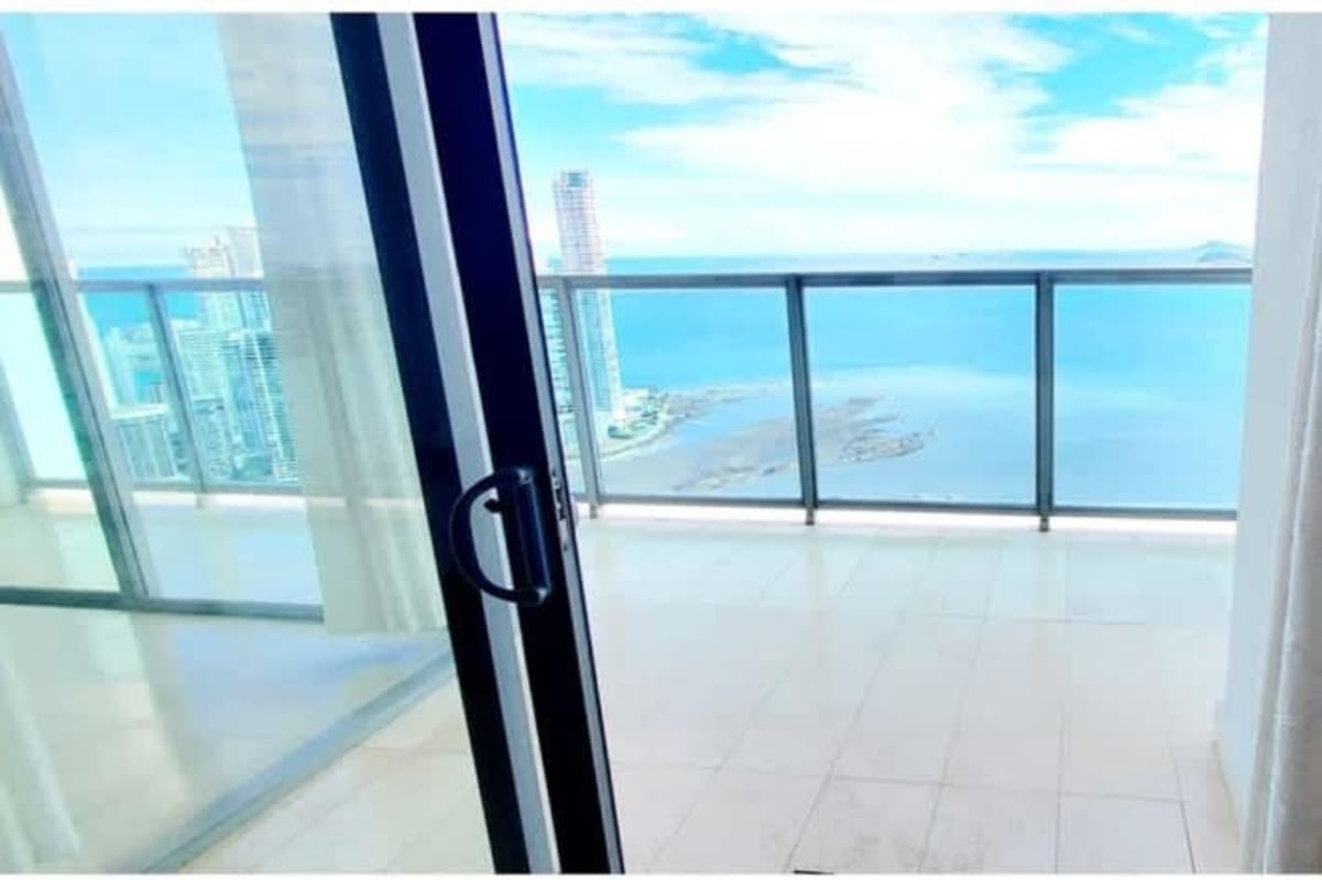Panoramic balcony with glass railing facing ocean view PH BICSA apartment rented by Hola Realty