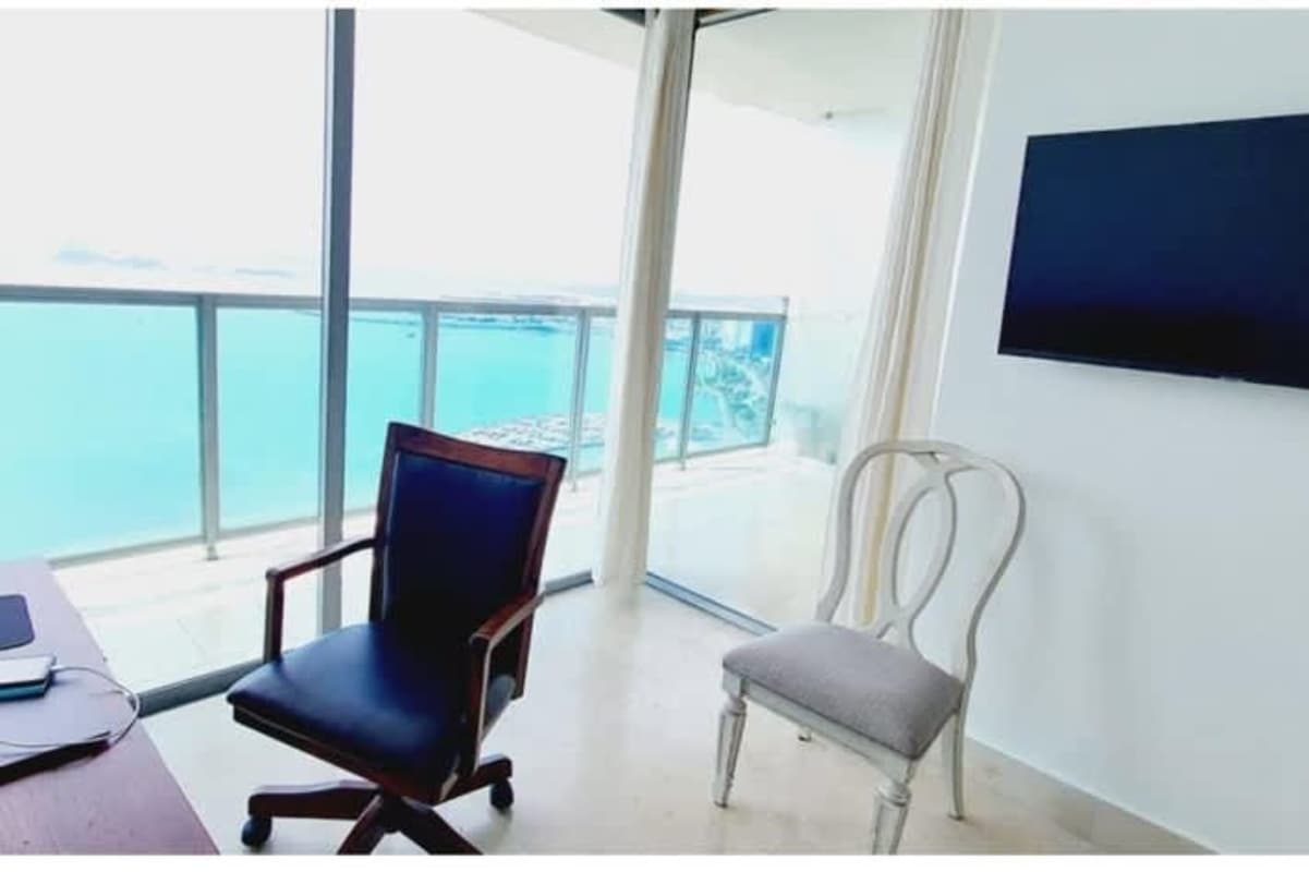 Modern home office with floor-to-ceiling ocean view windows in PH BICSA apartment