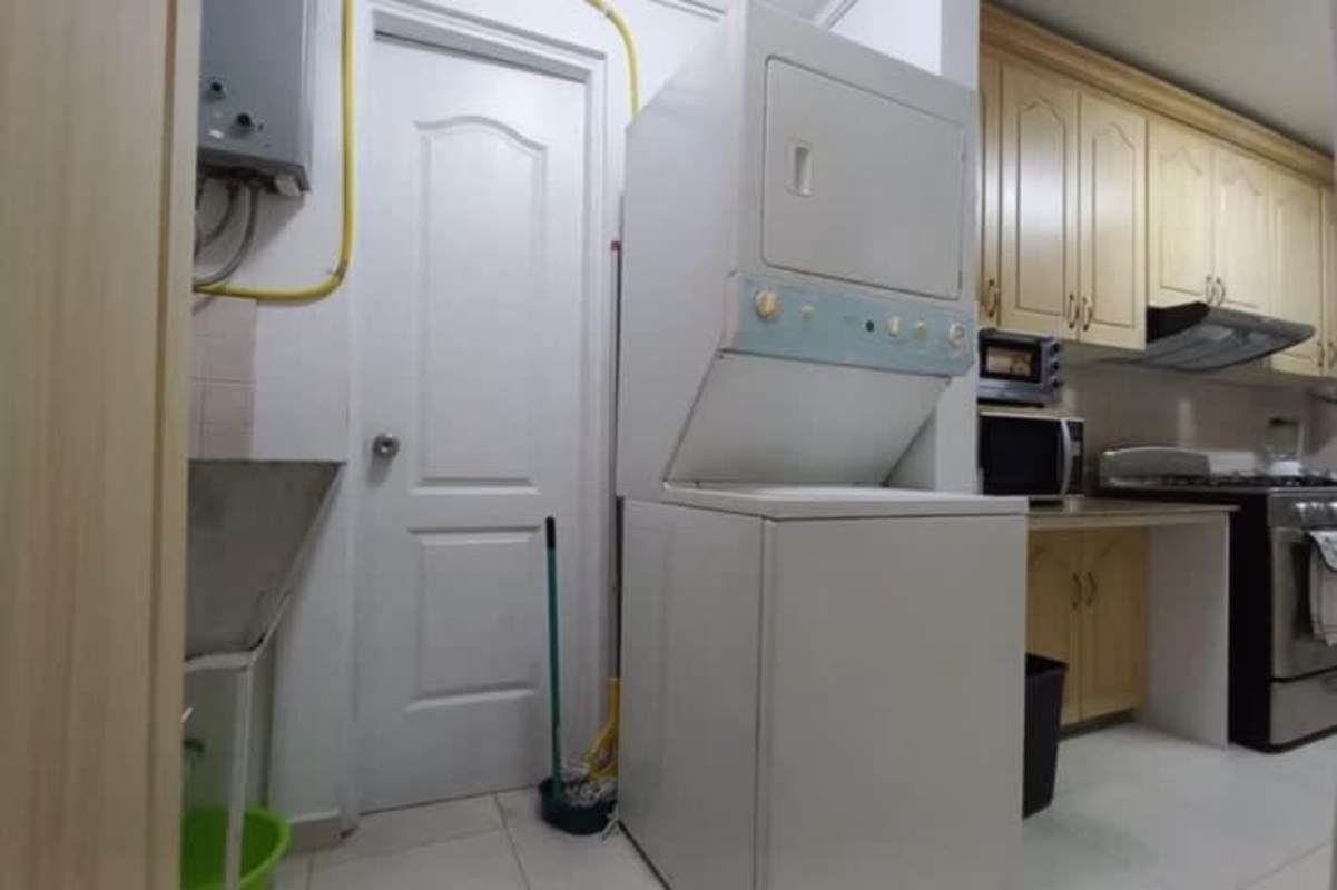 Laundry area with stacked washer dryer and gas water heater in Dos Mares View 1 Betania Panama