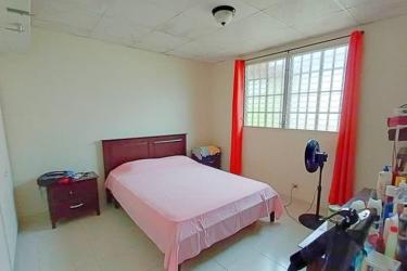 Traditional kitchen with granite counter and laundry space in Burunga Arraiján home