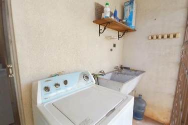 Bathroom featuring pedestal sink tiled wall shower curtain home for sale Burunga Panama