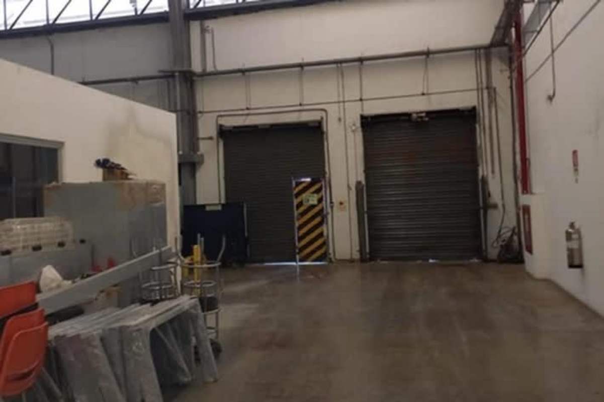 Industrial warehouse bay showing roller doors, warehouse equipment, and concrete flooring at Milla 8 Panama