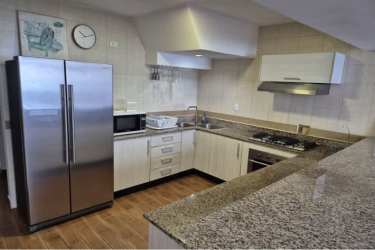 Two-level loft with wooden stairs and modern interior PH Miramar Loft Farallón Panama