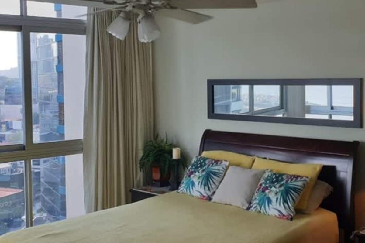 Furnished bedroom with large windows city and ocean view PH BICSA Avenue Balboa Panama