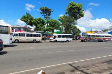 Urban street scene with public buses and commercial activity in Costa Verde La Chorrera Panama