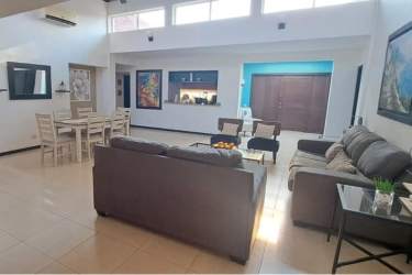 Contemporary kitchen with wood cabinets granite counters in beach home rental Villas Decameron Panama