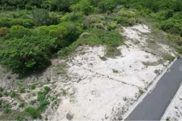 Vacant coastal property beside paved road in secure neighborhood Panama