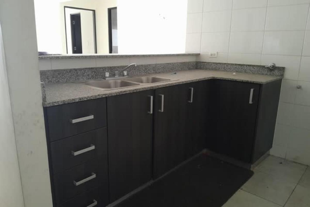 L-shaped modern kitchen with granite countertop and double sink in apartment for sale PH Parque Lefevre Panama City