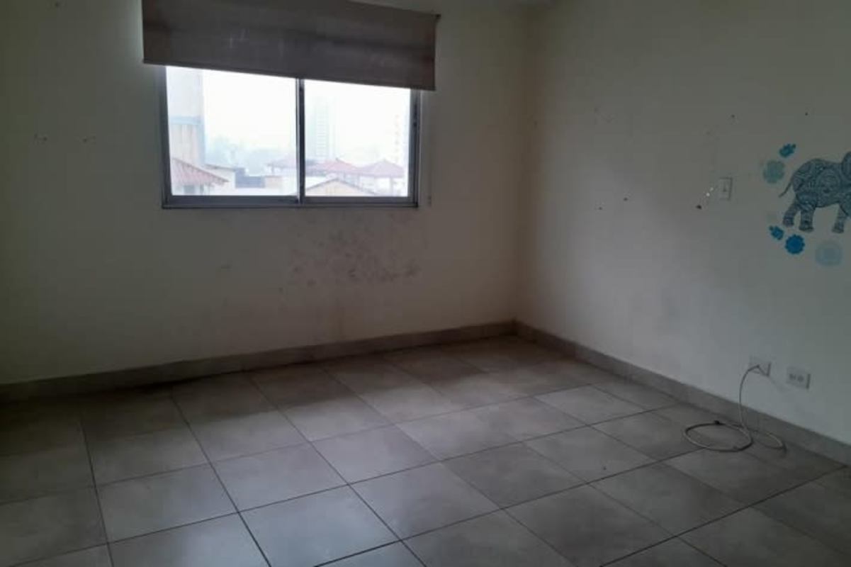 Unfurnished bedroom with tile floor, large window and built-in closet PH Parque Lefevre Panama