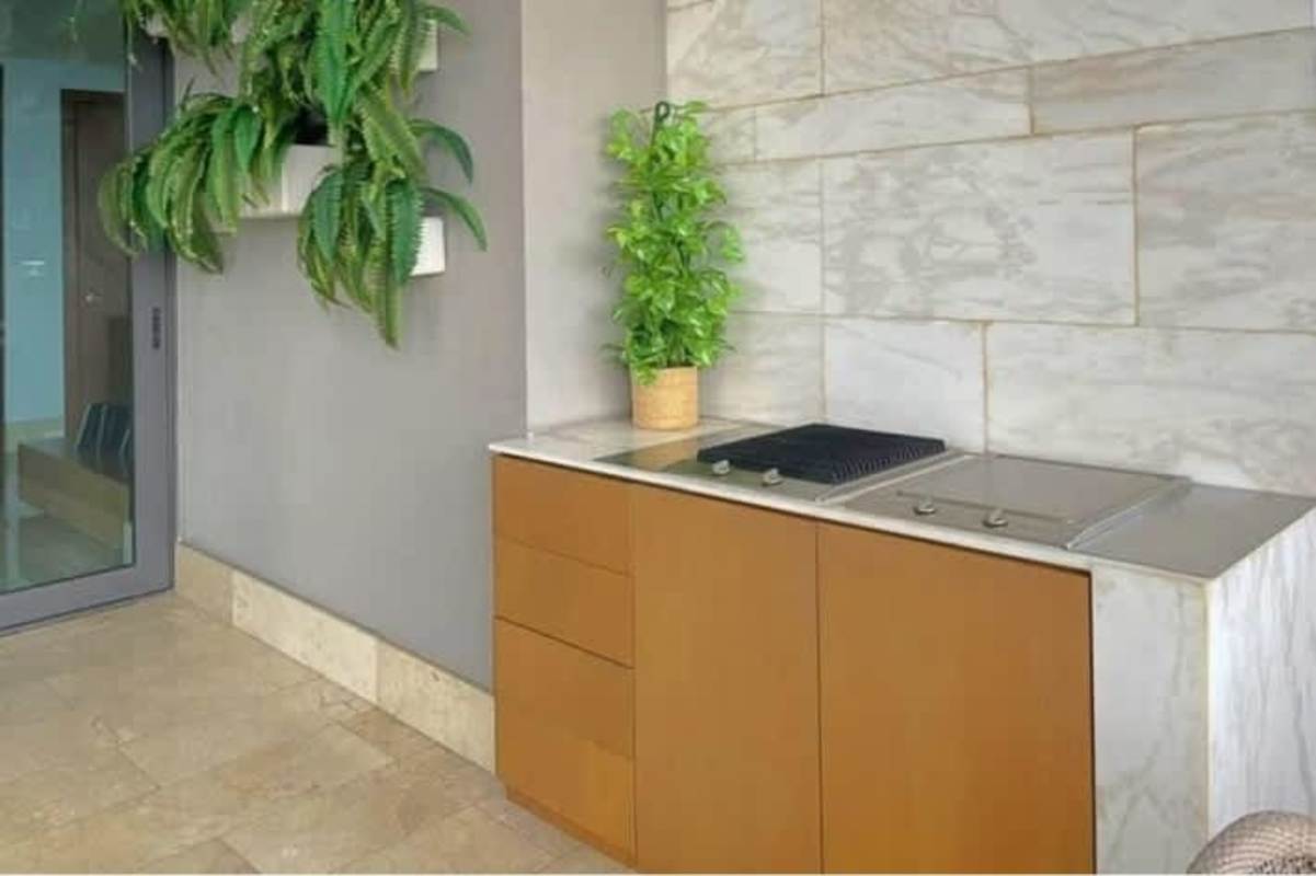 Outdoor grilling station with marble counters and greenery Santa María Panama