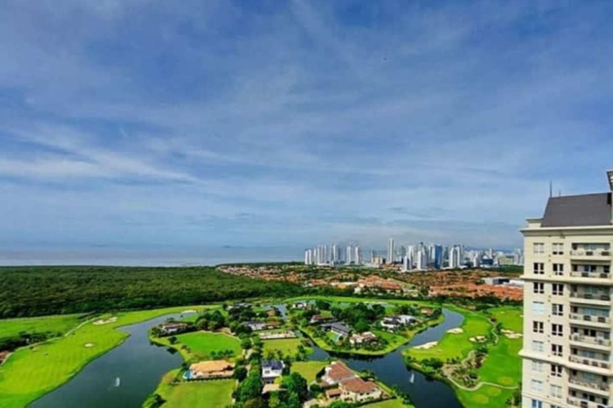Golf course surrounded by lush greenery and Panama City skyline at Santa María Country Club