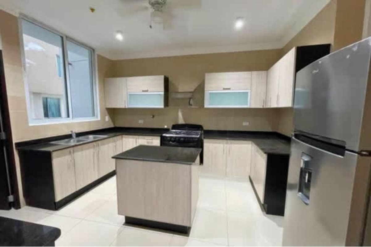 Kitchen with island, stainless appliances and marble counters Panama luxury apartment