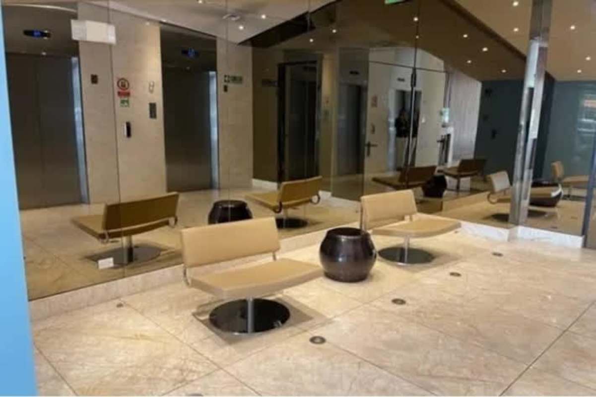 Modern commercial lobby with elevators, marble floors, large mirrors in Boulevard del Este tower Panama