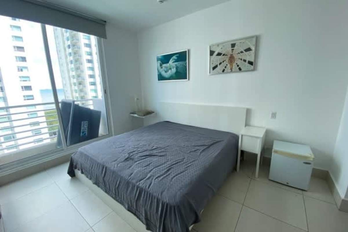 Minimalist bedroom decor with large windows, city and partial ocean view Costa del Este Panama apartment