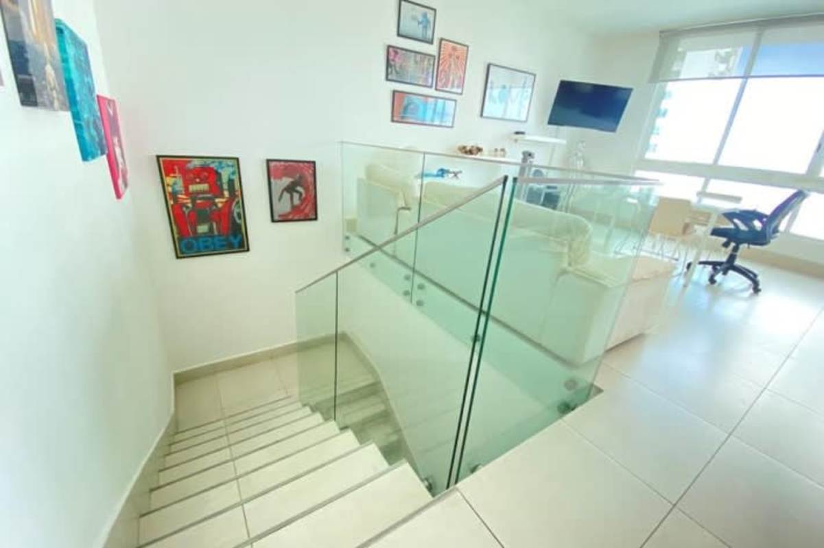 Loft apartment contemporary interior with glass railing staircase, open living area Costa del Este Panama