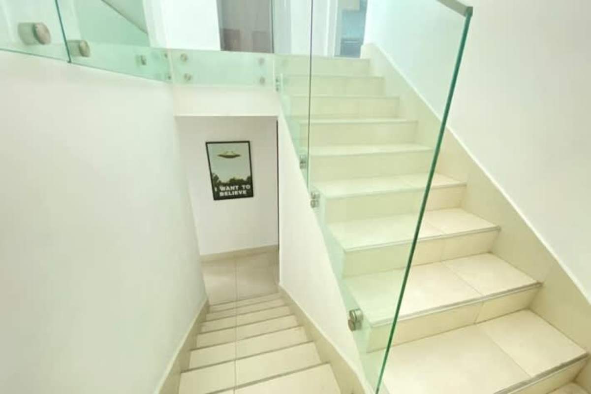 Minimalist staircase with glass railing inside luxury loft apartment in Costa del Este Panama