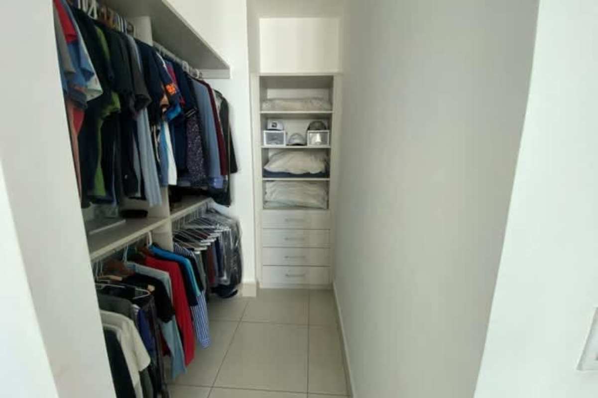 Bedroom with panoramic windows overlooking ocean and skyline in Costa del Este luxury apartment