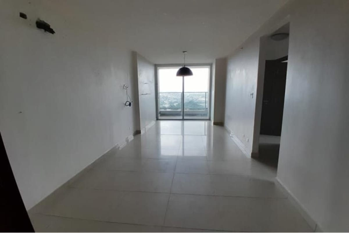 Spacious living and dining area with sliding glass door to balcony skyline views PH Vista Real Panama City