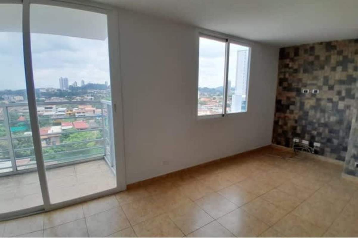 Bright open-concept living room with balcony city view at PH Park Royal Panama City