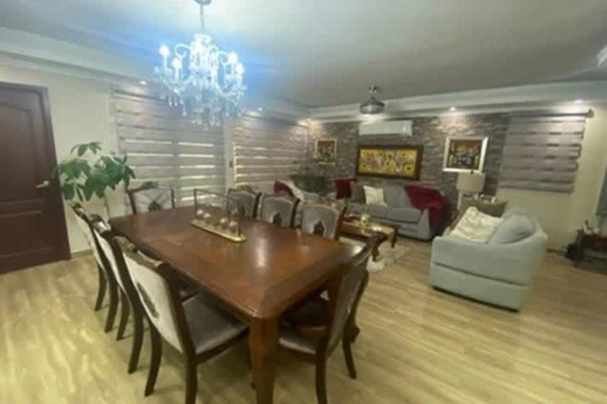 Living room with stone accent wall and modern furniture in Altos de Panamá House