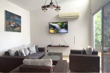 Kitchen with granite countertops, dark cabinetry, and bar seating in PH Ibiza Residences I