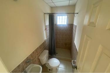 Simple kitchen with tiled backsplash and white cabinets affordable house Penonomé Panama