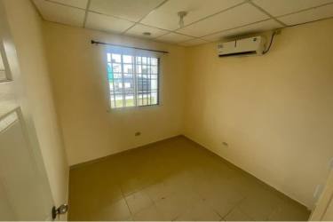 Bedroom with ceramic tiled floor window and security bars in affordable house for sale Coclé Panama