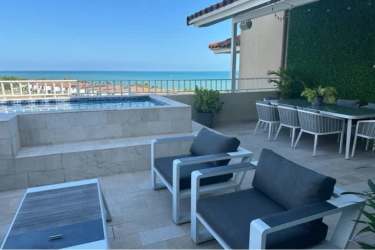 Modern terrace with pool, outdoor dining area and oceanfront views at Penthouse Buenaventura Panama