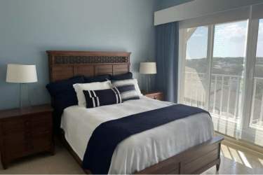 Guest bedroom with twin beds, beach balcony views in penthouse at PH Puntarenas Panama