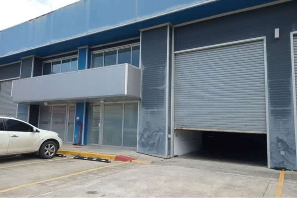 Modern industrial warehouses with roll-up doors and parking Tocumen Panama