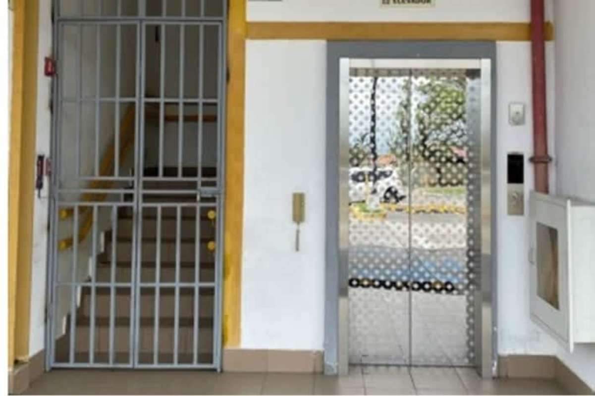 Building lobby elevator with reflective doors and security gate Plaza Santa Fe Tocumen Panama