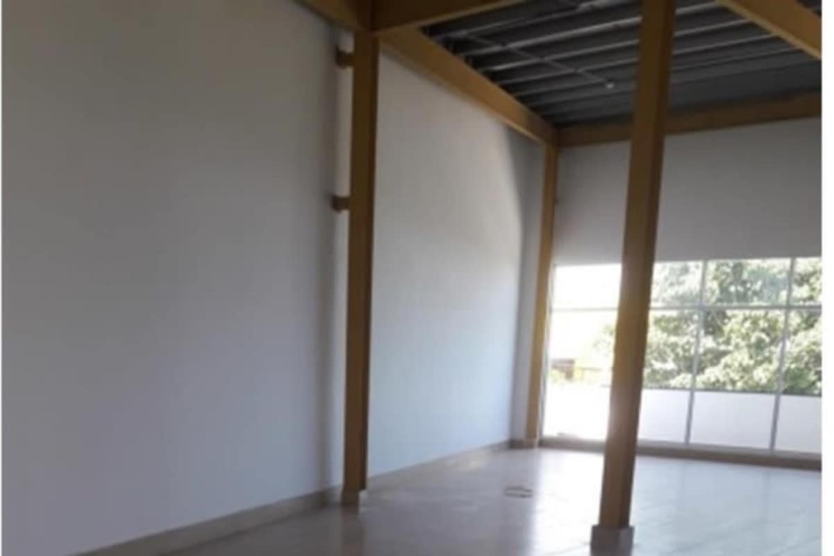 Exterior view Plaza Santa Fe commercial shopping plaza with signs parking in Tocumen Panama