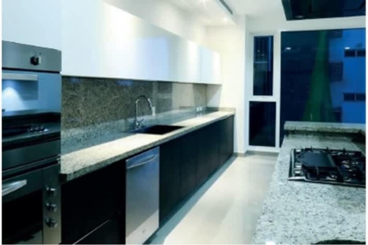 Contemporary kitchen with granite countertops stainless steel appliances at PH The Reserve apartment Panama