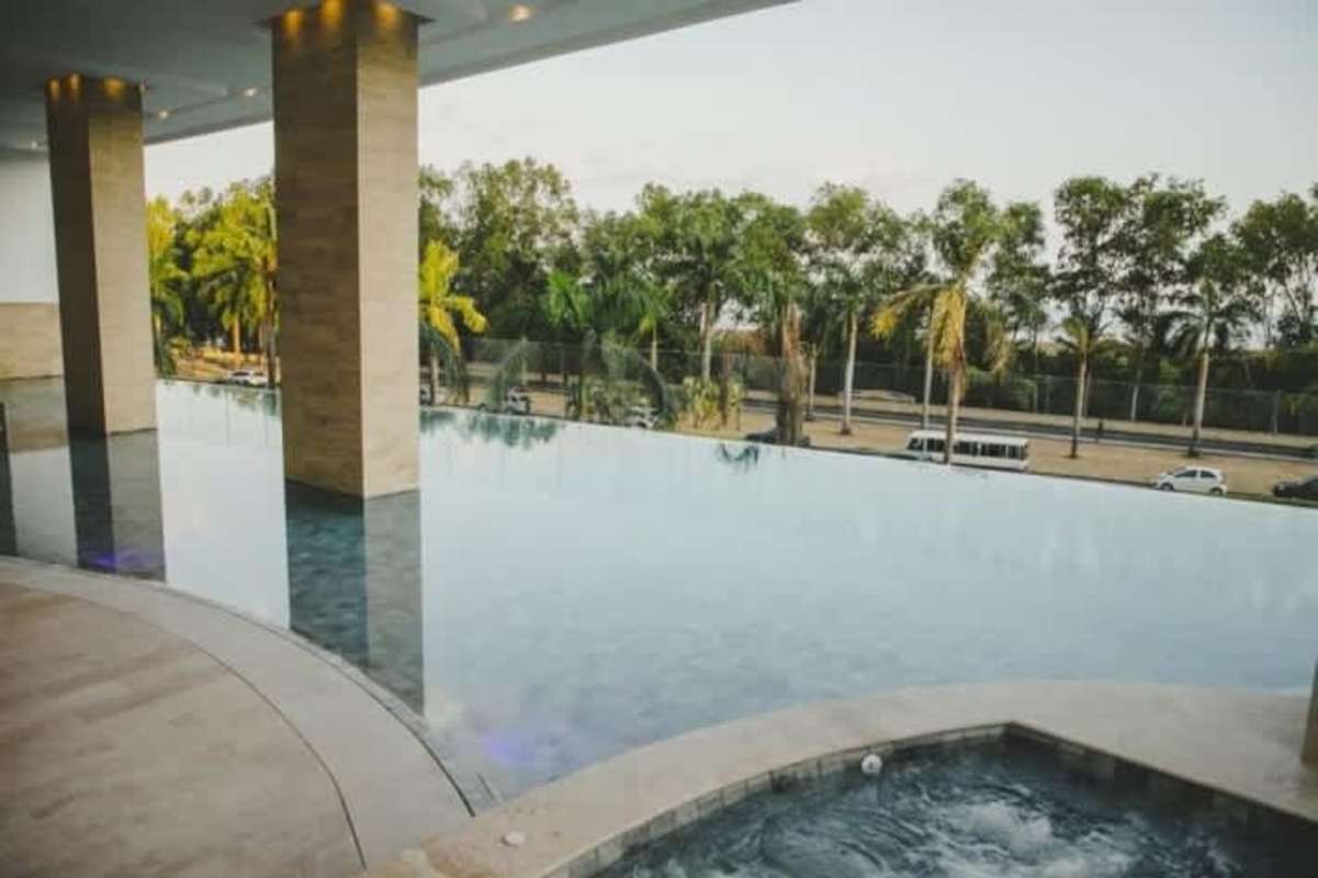 Elegant indoor lounge with floor-to-ceiling glass and pool view at PH The Reserve Costa del Este Panama