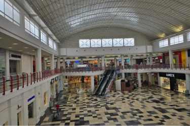 Glass ceiling, escalators and multiple retail stores inside Westland Mall Arraiján Panama